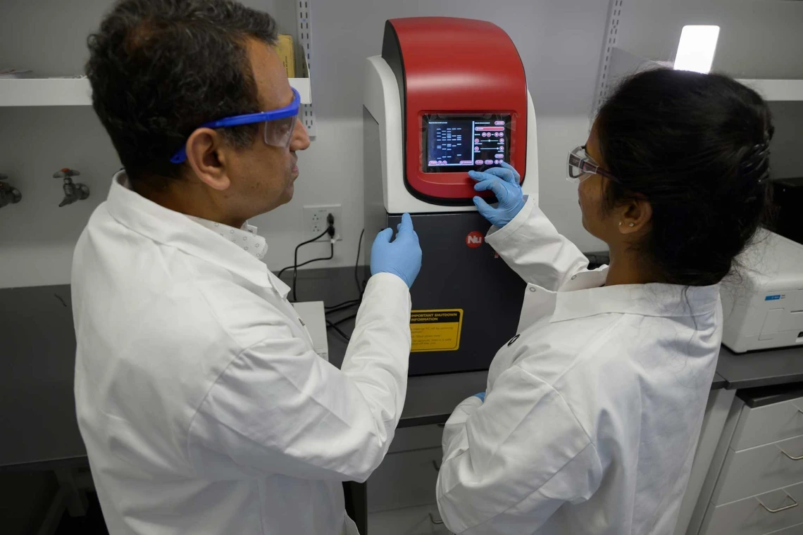 Researchers working with lab tech